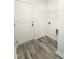 Laundry room with wood-look flooring, storage shelf, and hookups at 67 Furley St., Homesite 117, Sanford, NC 27330