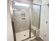 Modern shower with tiled walls, built-in bench, and glass door at 67 Furley St., Homesite 117, Sanford, NC 27330