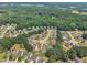 High-angle aerial view of a residential community nestled amongst lush trees and greenery at 71 Herndon Ct, Clayton, NC 27520
