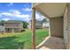 View of fenced backyard with a small concrete patio area and view to the neighboring houses at 71 Herndon Ct, Clayton, NC 27520
