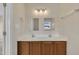 Bathroom showcasing dual sinks, light sconces, and a mirror, with a view from the window at 71 Herndon Ct, Clayton, NC 27520