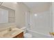 Bright bathroom with a shower and tub combination, neutral tile, and a vanity with sink at 71 Herndon Ct, Clayton, NC 27520