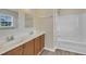 Bathroom featuring double sinks, a tub and shower combination, and a view from the window at 71 Herndon Ct, Clayton, NC 27520