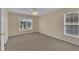 Bedroom featuring carpet, a ceiling fan, and natural light from two windows at 71 Herndon Ct, Clayton, NC 27520
