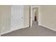 Neutral bedroom featuring carpet, a closet, and a bathroom through the open door at 71 Herndon Ct, Clayton, NC 27520