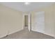 Bedroom with beige walls, plush carpeting, and white doors at 71 Herndon Ct, Clayton, NC 27520