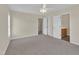 Bedroom showcasing a ceiling fan, carpet, and neutral paint, with bathroom and closet entrances at 71 Herndon Ct, Clayton, NC 27520