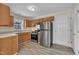 Updated kitchen with stainless steel refrigerator, and wood cabinets at 71 Herndon Ct, Clayton, NC 27520