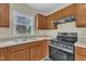Updated kitchen featuring stainless steel stove, oven and wood cabinets at 71 Herndon Ct, Clayton, NC 27520
