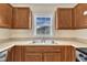 A kitchen featuring wood cabinets, stainless steel sink, and updated countertops at 71 Herndon Ct, Clayton, NC 27520