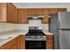 A kitchen featuring updated appliances and wood cabinets at 71 Herndon Ct, Clayton, NC 27520