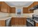 Modern kitchen with stainless steel dishwasher and oven beneath wood cabinets at 71 Herndon Ct, Clayton, NC 27520