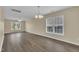 Bright, open living room featuring hardwood floors, ample natural light, and a modern chandelier at 71 Herndon Ct, Clayton, NC 27520