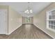 Bright and airy living room with hardwood floors, a modern chandelier, and abundant natural light at 71 Herndon Ct, Clayton, NC 27520
