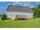 The home's backyard showcases a wooden deck, offering an ideal outdoor relaxation and entertainment space at 7107 Elkhorn Rd, Rocky Mount, NC 27803
