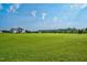 Expansive, well-maintained backyard perfect for recreation, framed by serene natural surroundings and blue sky at 7107 Elkhorn Rd, Rocky Mount, NC 27803