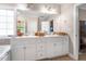 Bathroom vanity with double sinks, white cabinetry, and large mirror with overhead lighting at 7107 Elkhorn Rd, Rocky Mount, NC 27803