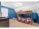 Colorful room featuring a bunk bed with sports-themed decor and bright blue walls at 7107 Elkhorn Rd, Rocky Mount, NC 27803