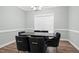 Formal dining room featuring modern light fixture and large window at 7107 Elkhorn Rd, Rocky Mount, NC 27803