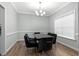 Formal dining room featuring modern light fixture and large window at 7107 Elkhorn Rd, Rocky Mount, NC 27803