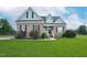 Inviting brick home featuring a manicured lawn and tasteful landscaping at 7107 Elkhorn Rd, Rocky Mount, NC 27803