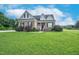 Inviting brick home featuring a manicured lawn and tasteful landscaping at 7107 Elkhorn Rd, Rocky Mount, NC 27803