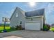 Attached garage with an extended driveway, complemented by tidy landscaping and a basketball hoop at 7107 Elkhorn Rd, Rocky Mount, NC 27803