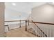 Upper level hallway featuring carpeted floors, white railings, and bright interior at 7107 Elkhorn Rd, Rocky Mount, NC 27803