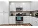 Bright kitchen features white cabinets, stainless steel appliances, and modern countertops at 7107 Elkhorn Rd, Rocky Mount, NC 27803
