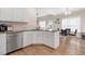 This kitchen features white cabinets, stainless steel appliances and granite countertops at 7107 Elkhorn Rd, Rocky Mount, NC 27803