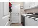 Convenient laundry room with modern washer and dryer, ample storage and tile flooring at 7107 Elkhorn Rd, Rocky Mount, NC 27803