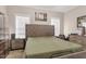 Neutral-toned bedroom showcasing a large bed, side tables, and windows providing natural light at 7107 Elkhorn Rd, Rocky Mount, NC 27803