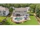 A sprawling backyard oasis with a pool, hot tub, patio, and lush greenery; perfect for outdoor living at 7410 Chouder Ln, Wake Forest, NC 27587