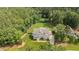 Beautifully landscaped property featuring a well-maintained lawn and a charming two-story home surrounded by lush greenery at 7410 Chouder Ln, Wake Forest, NC 27587