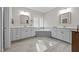 Bright bathroom with dual vanities, framed mirrors, and a separate soaking tub at 7410 Chouder Ln, Wake Forest, NC 27587