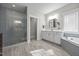 Large primary bathroom featuring glass shower and separate soaking tub at 7410 Chouder Ln, Wake Forest, NC 27587
