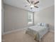 Cozy bedroom with neutral carpet, a ceiling fan, and a bright window for natural light at 7410 Chouder Ln, Wake Forest, NC 27587