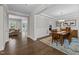 A formal dining room features hardwood floors, a tray ceiling, and wainscoting that connects to the living area at 7410 Chouder Ln, Wake Forest, NC 27587