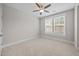 Bright empty bedroom with ceiling fan and large window at 7410 Chouder Ln, Wake Forest, NC 27587