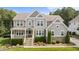 Charming two-story home with stone accents, manicured landscaping, and welcoming front porch at 7410 Chouder Ln, Wake Forest, NC 27587
