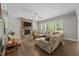 Bright living room features a stone fireplace, large windows, and hardwood floors at 7410 Chouder Ln, Wake Forest, NC 27587