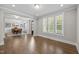 An open-concept living room features hardwood floors and natural light, leading into a dining area at 7410 Chouder Ln, Wake Forest, NC 27587