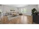 Bright living room featuring hardwood floors and large window with view at 7410 Chouder Ln, Wake Forest, NC 27587
