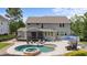 An inviting backyard with a pool, hot tub, lounge chairs, and a covered patio; perfect for outdoor entertaining at 7410 Chouder Ln, Wake Forest, NC 27587