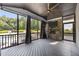 Screened porch overlooking pool with fireplace and TV at 7410 Chouder Ln, Wake Forest, NC 27587