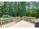 Elevated back deck with wooden railing overlooking a serene wooded backyard at 776 Legend Oaks Dr, Chapel Hill, NC 27517