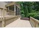 Inviting back deck with screened-in porch and a relaxing hot tub surrounded by lush greenery at 776 Legend Oaks Dr, Chapel Hill, NC 27517