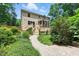 Expansive backyard featuring a screened-in porch, wooden deck, and landscaped garden at 776 Legend Oaks Dr, Chapel Hill, NC 27517
