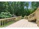 Expansive wooden deck overlooking a private, tree-lined backyard with string lights at 776 Legend Oaks Dr, Chapel Hill, NC 27517