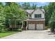 Charming two-story home featuring brick facade, a two-car garage, covered porch, and well-maintained landscaping at 776 Legend Oaks Dr, Chapel Hill, NC 27517